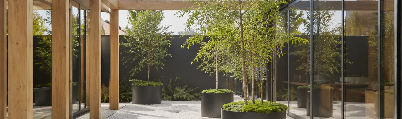 giantA BASIX & NatHERS compliant design — biophilic commercial atrium integrating mature planters, daylight glazing and passive shading to deliver thermal comfort and energy efficiency targets